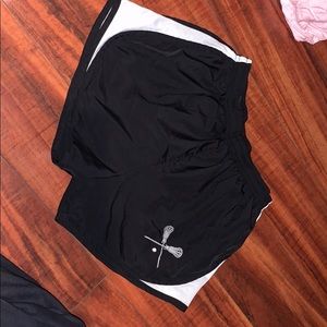 running shorts with lacrosse stick logo